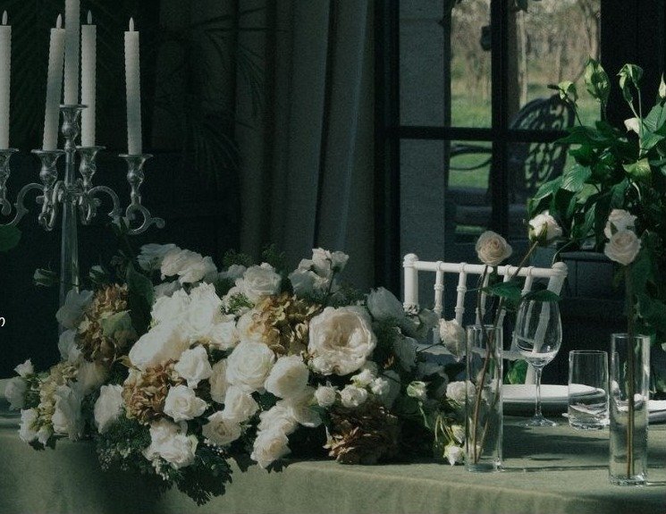 Elegant wedding table styled with white flowers and candles